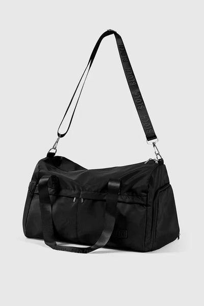 Bloch Black duffel bag with a strap on a light gray background