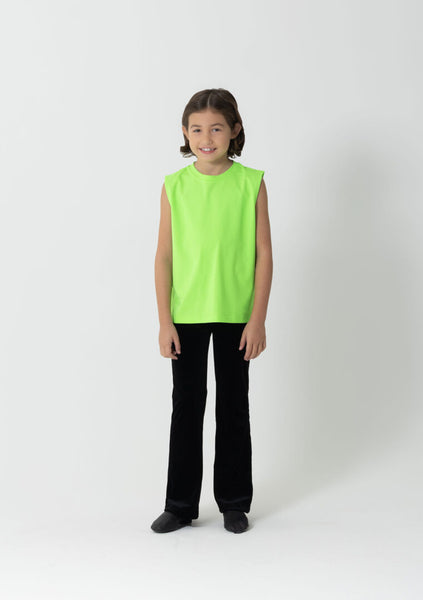 Child wearing a bright green sleeveless top and black pants on a white background