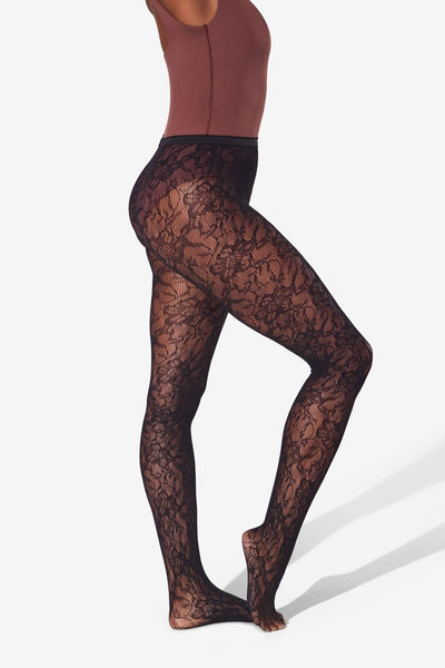 Black lace tights worn by a model on a white background