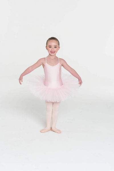 A young child wearing a pink four-layer tutu dress with a princess lines bodice and adjustable straps.