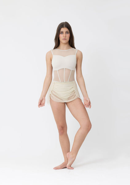 Woman wearing a cream bodysuit with matching ruffle skirt on a white background