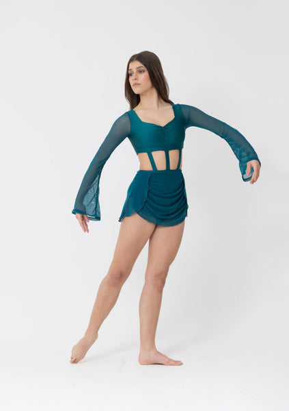 Woman wearing a teal dance outfit with long sleeves and cut-out design on a white background