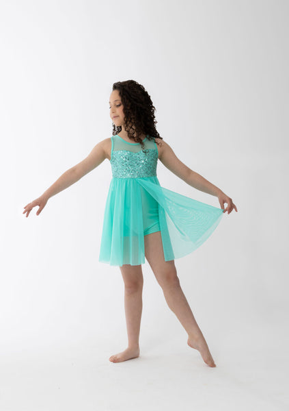 Woman wearing a Mint dress with sheer panels on a white background