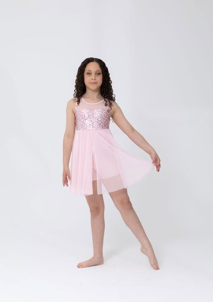 Woman wearing a Pale Pink dress with sheer panels on a white background