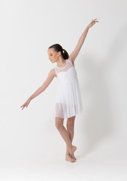 Woman wearing a white dress with sheer panels on a white background