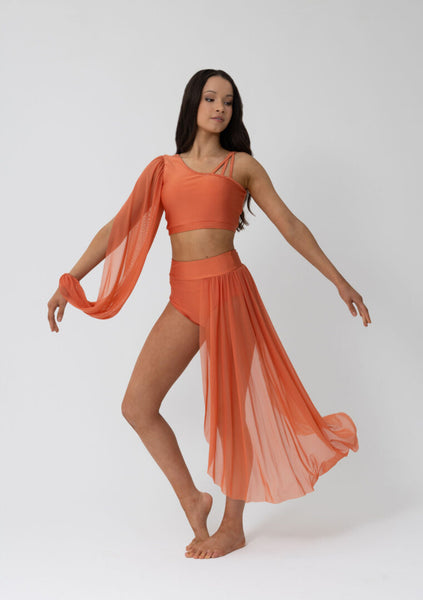 Dancer in an copper outfit with a flowing skirt on a white background