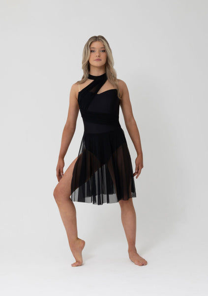 Woman wearing a black dress with sheer overlay on a white background