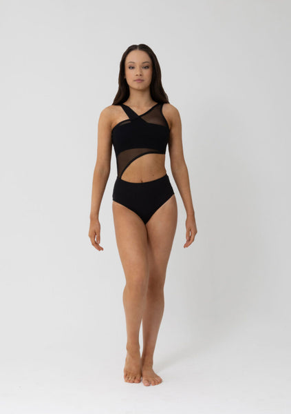 woman wearing black crop top with sheet black leotard over the top on a white background