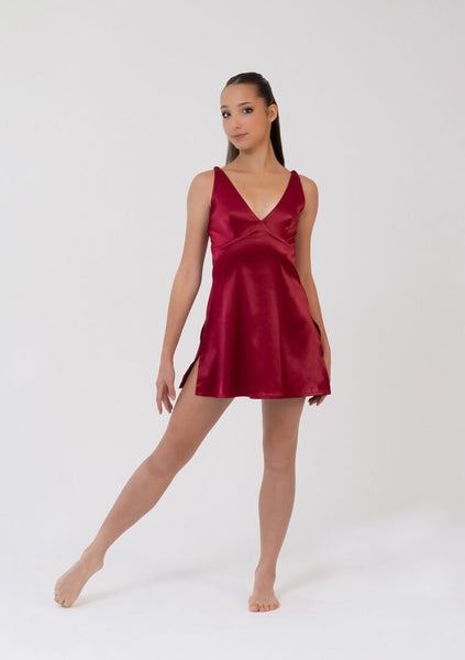 Woman wearing a burgundy satin nightgown on a white background