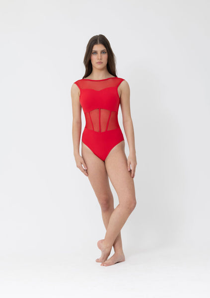 Woman wearing a red leotard with mesh panelling on a white background