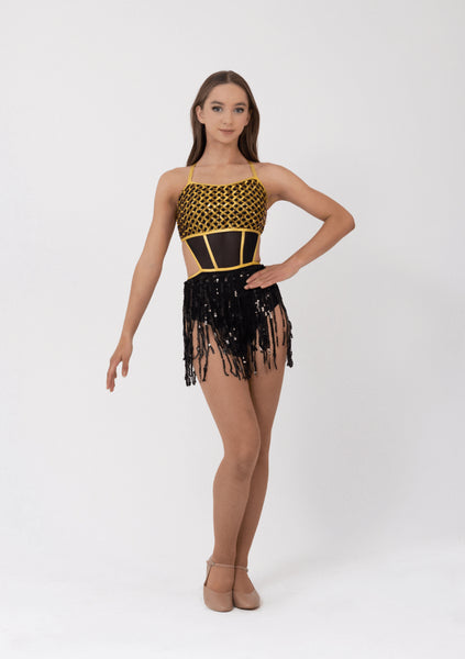 Dancer wearing a black and gold leotard with fringe on a white background