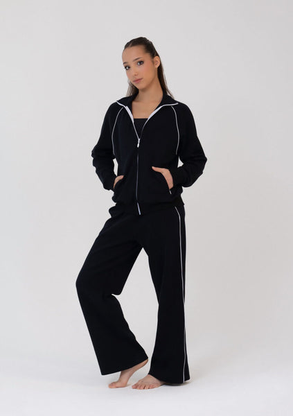 Person wearing a black tracksuit on a white background