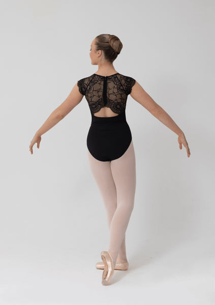 Ballerina in a black leotard with lace detailing on a white background