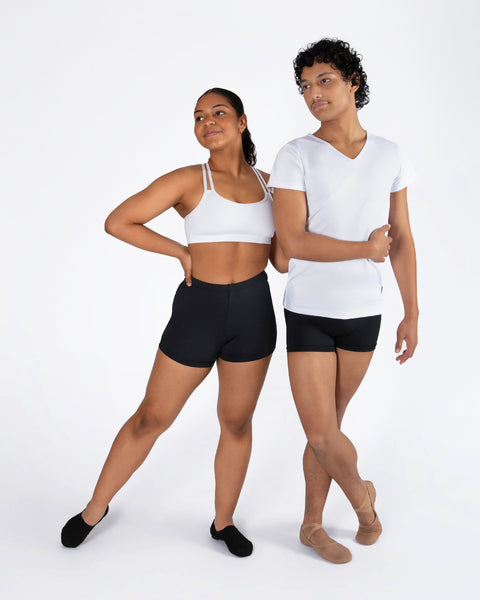 Two people wearing a unisex high cut black shorts with a white t shirt or white crop