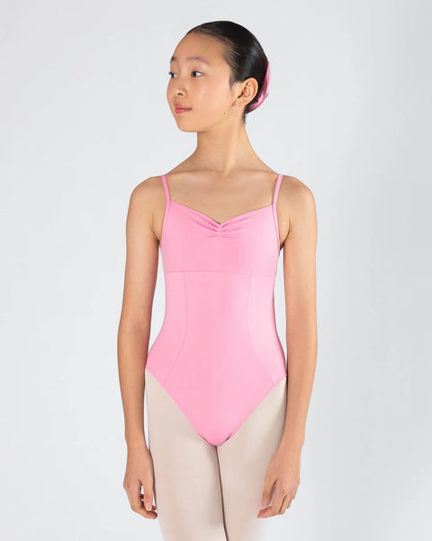 Young girl wearing a pink leotard on a white background