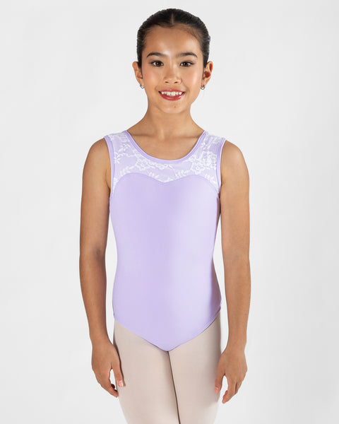 A young girl dancer wearing a lavender sleeveless leotard with white lace trim across the chest, paired with light beige tights, photographed against a solid light gray background.