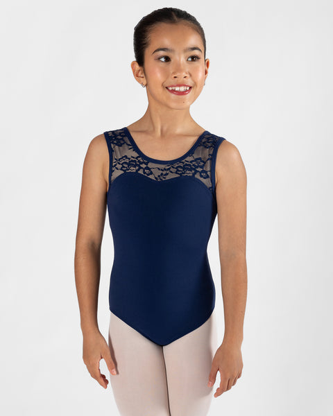 A young girl dancer wearing a navy blue sleeveless leotard with navy lace detailing across the chest, paired with light pink tights, photographed against a solid light gray background.
