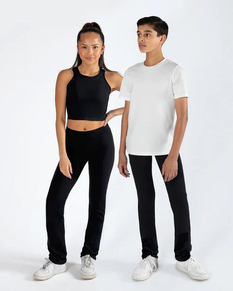 Two people wearing black pants and white shirts on a white background