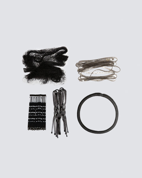 Collection of Black hair accessories including hair ties, clips, and a rubber band on a light gray background.