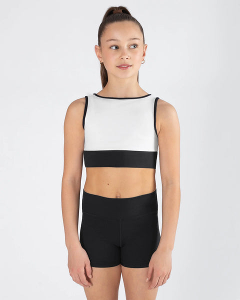 Woman wearing a black and white sleeveless top with black shorts on a white background