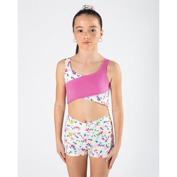Woman wearing a Pink and floral cross front sports bra and Floral shorts set on a white background