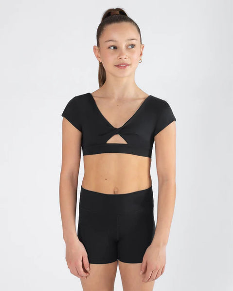 Person wearing a black crop top  with cut out and shorts on a white background
