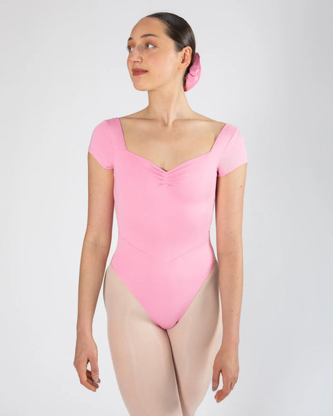 Person wearing a Petal Pink cap-sleeve leotard on a white background