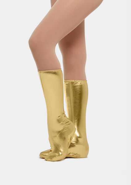 A pair of metallic gold dance spats worn over the shoes, extending up to the lower calf area.