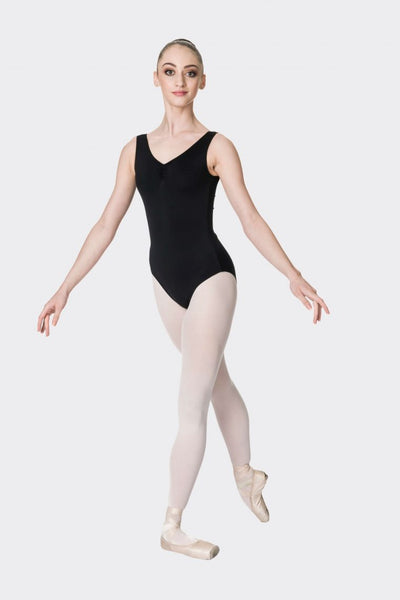 A person wearing a black sleeveless ballet leotard with thick straps and a high back, posed on one leg.